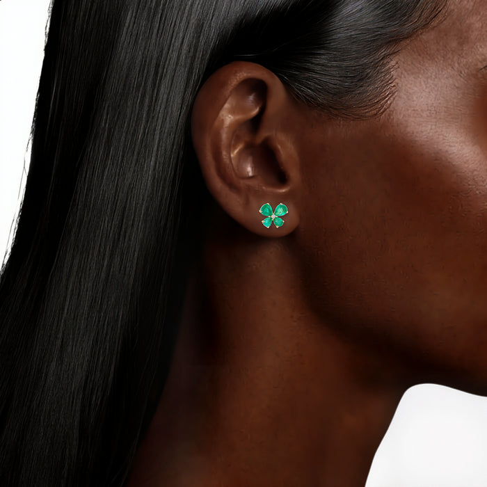 Pear Colombian Emerald Colorless Near-Flawless Diamond Butterfly Stud Earrings (2 ct. tw.) in 14k Yellow Gold shown on the ear (deepest skin tone)