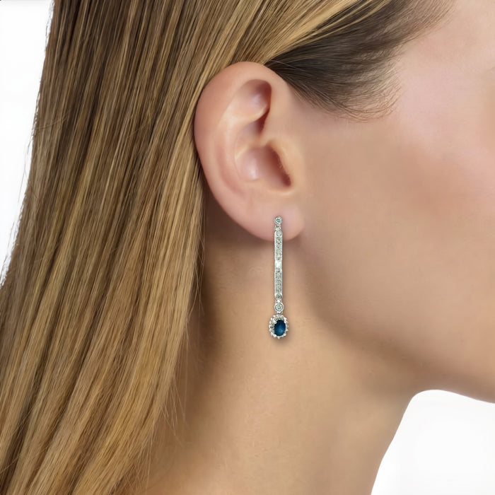 Oval Deep Blue Sapphire Colorless Near-Flawless Diamond Drop Earrings (1 ⅘ ct. tw.) in 14k White Gold shown on the ear (light medium skin tone)