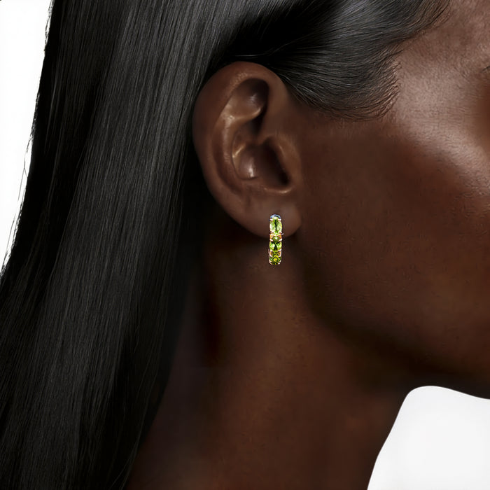 Oval Peridot Half Hoop Earrings (4 ct. tw.) in 10k Yellow Gold shown on the ear (deepest skin tone)