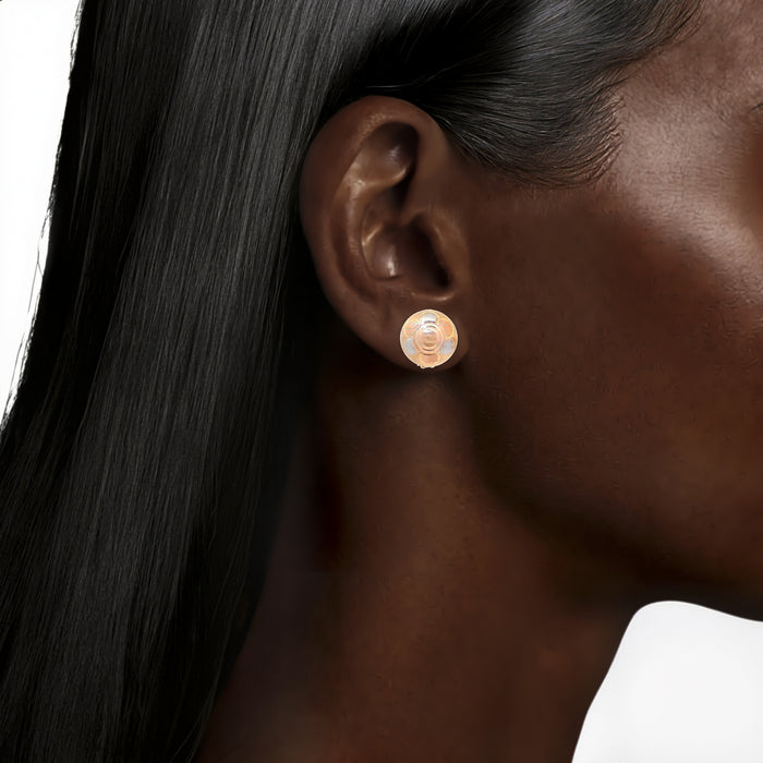 Tri-Color 14k Gold Button Huggie Earrings in Yellow, White & Rose Gold shown on the ear (deepest skin tone)