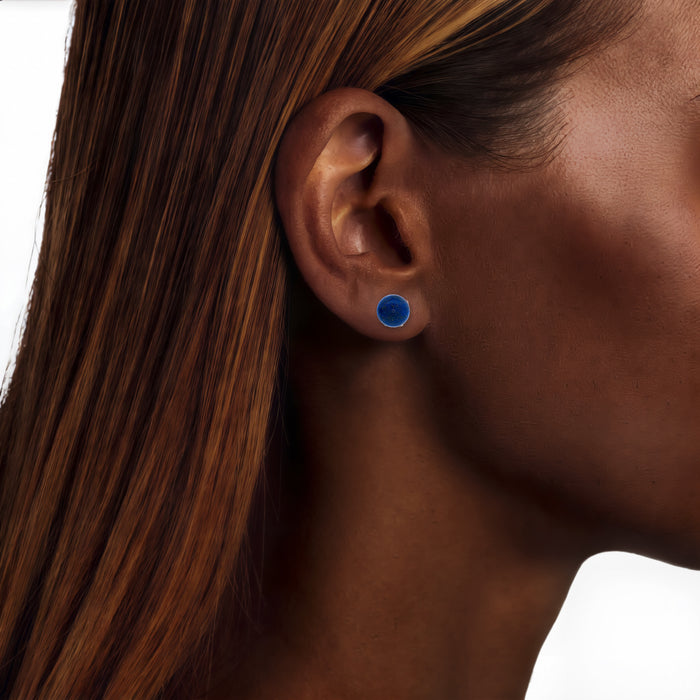 Blue Lapis Lazuli Stud Earrings (8mm) in 18k Yellow Gold shown on the ear (deep skin tone)