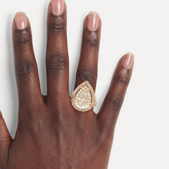 Pear-Shaped Nearly Flawless Colorless Diamond Cluster Ring (1 ¼ ct. tw.) in 18k Rose Gold shown on a hand (deep skin tone)
