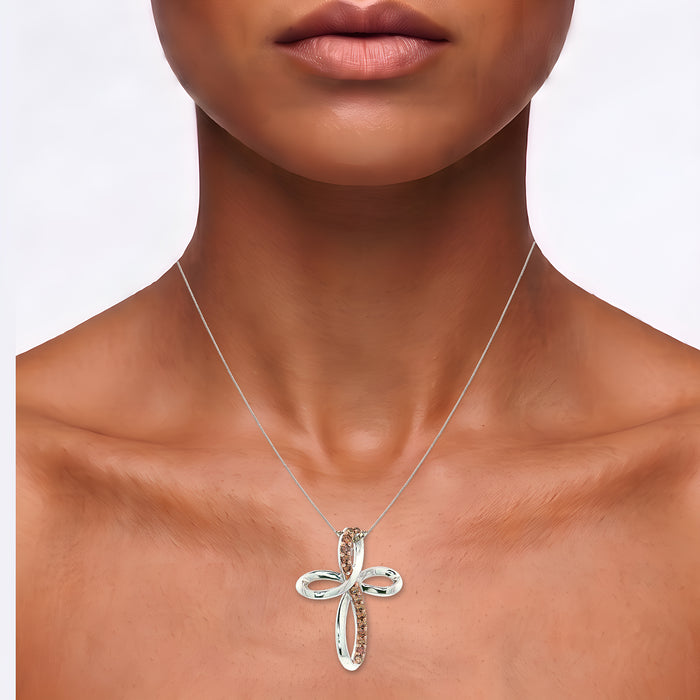 Pavé Cognac Cubic Zirconia Infinity Cross Pendant Necklace in Sterling Silver shown on the neck (medium deep skin tone)