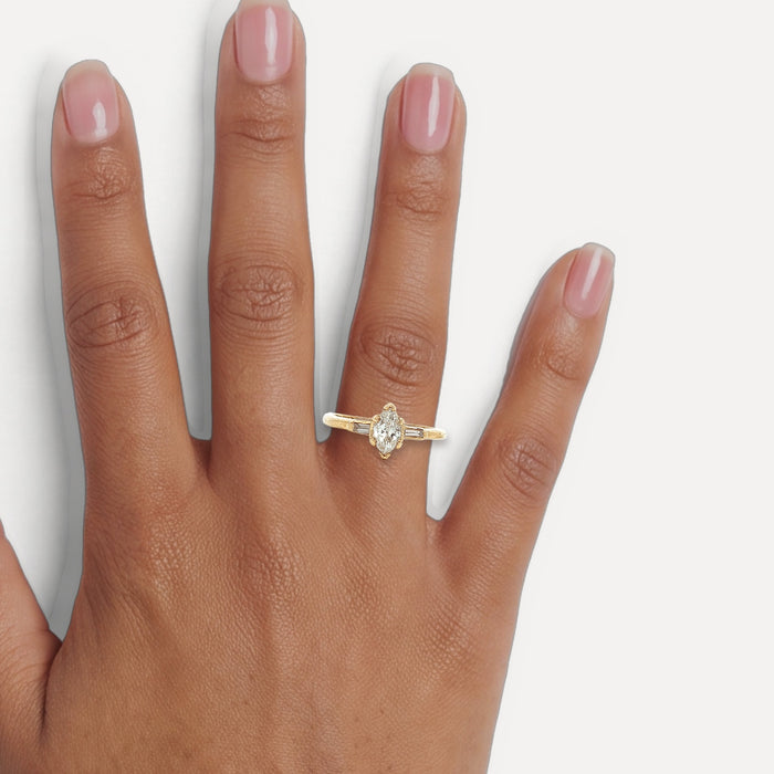 Marquise Baguette Colorless Diamond Engagement Ring (⅗ ct. tw.) in 14k Yellow Gold shown on a hand (medium deep skin tone)