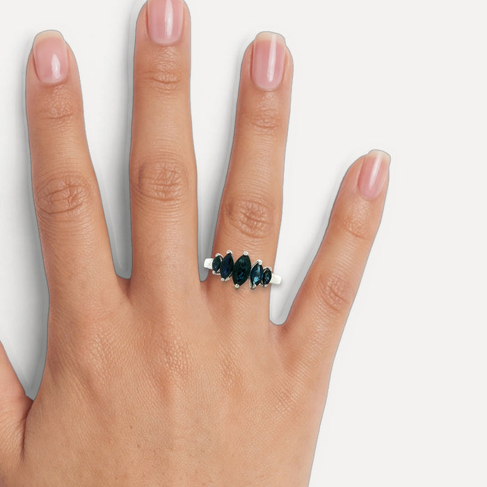 Graduating Marquise Cut Deep Vivid Blue Sapphire Ring (2 ct.) in 14k White Gold shown on a hand (medium skin tone)