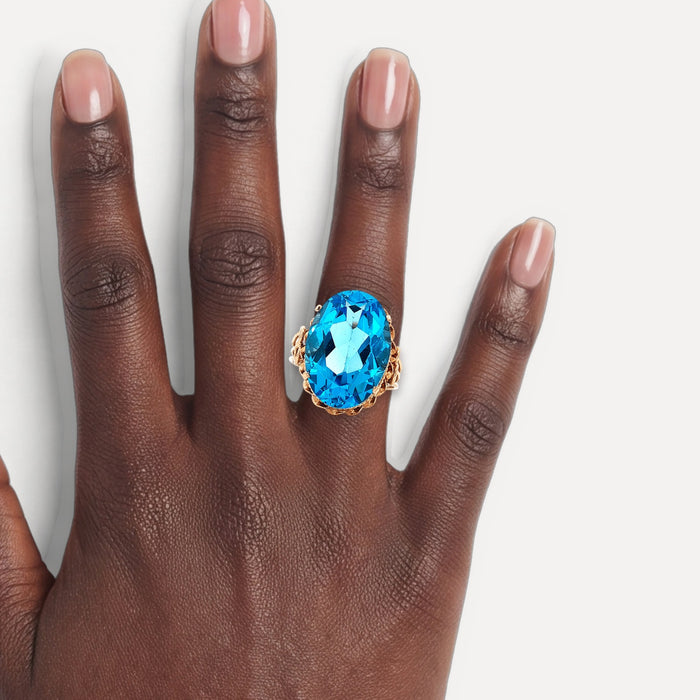 Vintage Oval-Shaped London Blue Topaz Ring (17 ct.) in 14k Rose Gold shown on a hand (deep skin tone)