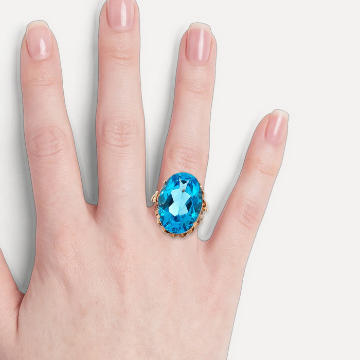 Vintage Oval-Shaped London Blue Topaz Ring (17 ct.) in 14k Rose Gold shown on a hand (light skin tone)