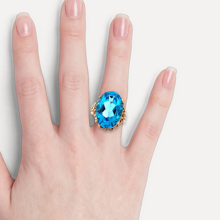 Vintage Oval-Shaped London Blue Topaz Ring (17 ct.) in 14k Rose Gold shown on a hand (light skin tone)