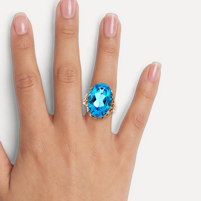 Vintage Oval-Shaped London Blue Topaz Ring (17 ct.) in 14k Rose Gold shown on a hand (medium skin tone)