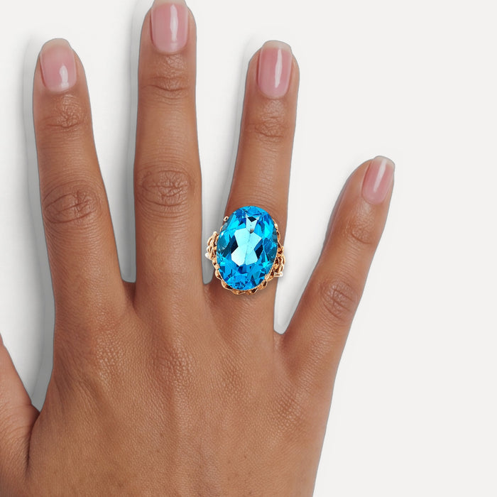 Vintage Oval-Shaped London Blue Topaz Ring (17 ct.) in 14k Rose Gold shown on a hand (medium deep skin tone)