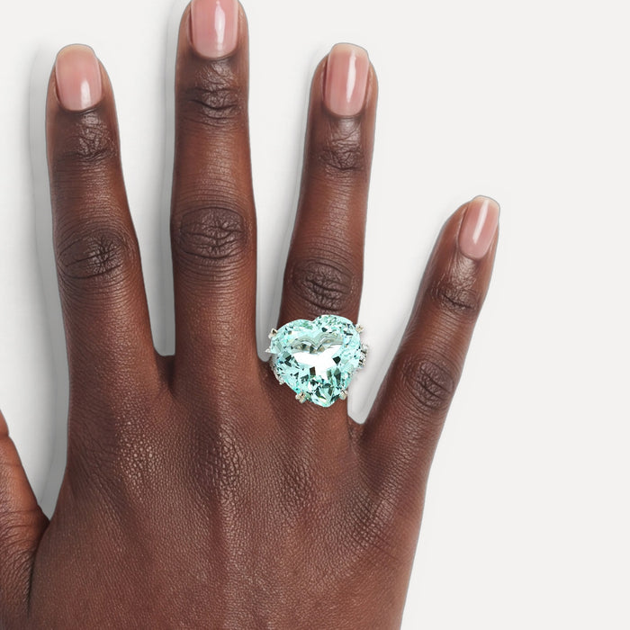 GIA Certified Heart-Shaped Vivid Aquamarine & Diamond Ring (25 ½ ct. tw.) in Platinum shown on a hand (deep skin tone)