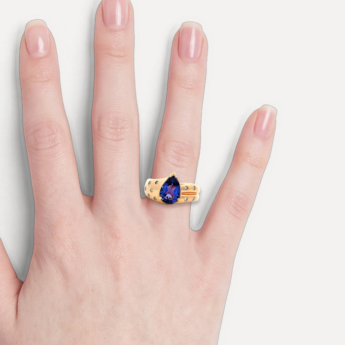 Vivid Pear Tanzanite Colorless Nearly Flawless Diamond Ring (3 ct. tw.) in 18k Rose Gold shown on a hand (light skin tone)