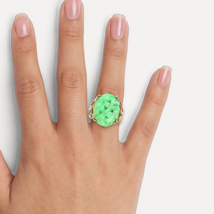 Vintage Large Hand Carved Oval Shaped Jade Ring in 14k Yellow Gold shown on a hand (medium skin tone)