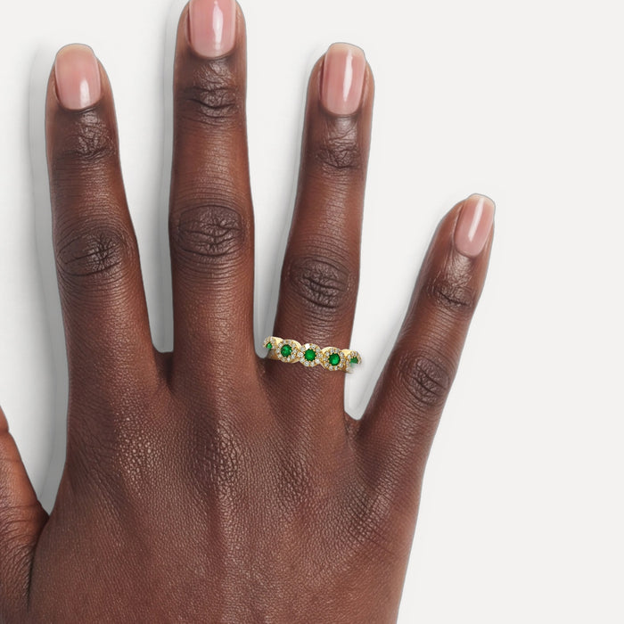 Emerald & Colorless Diamond Halo Wedding Band (⅘ ct. tw.) in 14k Yellow Gold shown on a hand (deep skin tone)