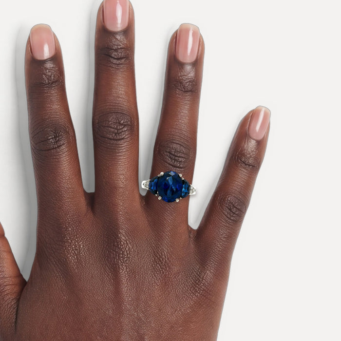 Moon Phase Sapphire Colored CZ Triple-Stone Ring in Sterling Silver shown on a hand (deep skin tone)