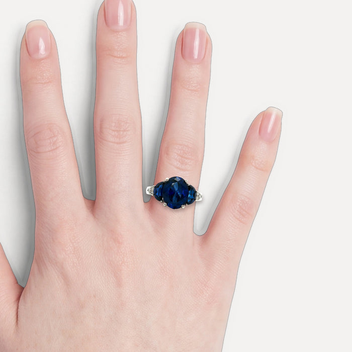 Moon Phase Sapphire Colored CZ Triple-Stone Ring in Sterling Silver shown on a hand (light skin tone)