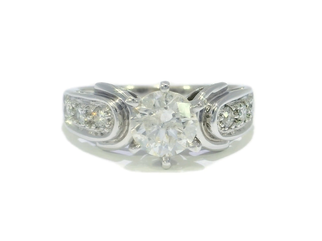 A round brilliant diamond engagement ring with intricate detailing, set in a white gold band