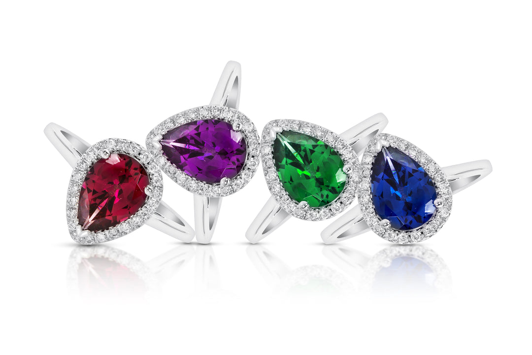 Ruby, amethyst, emerald, and sapphire gemstones — birthstones for July, February, May, and September