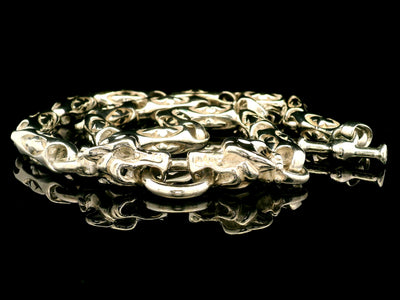 Men's sterling silver chain necklace with panther head links on a black background