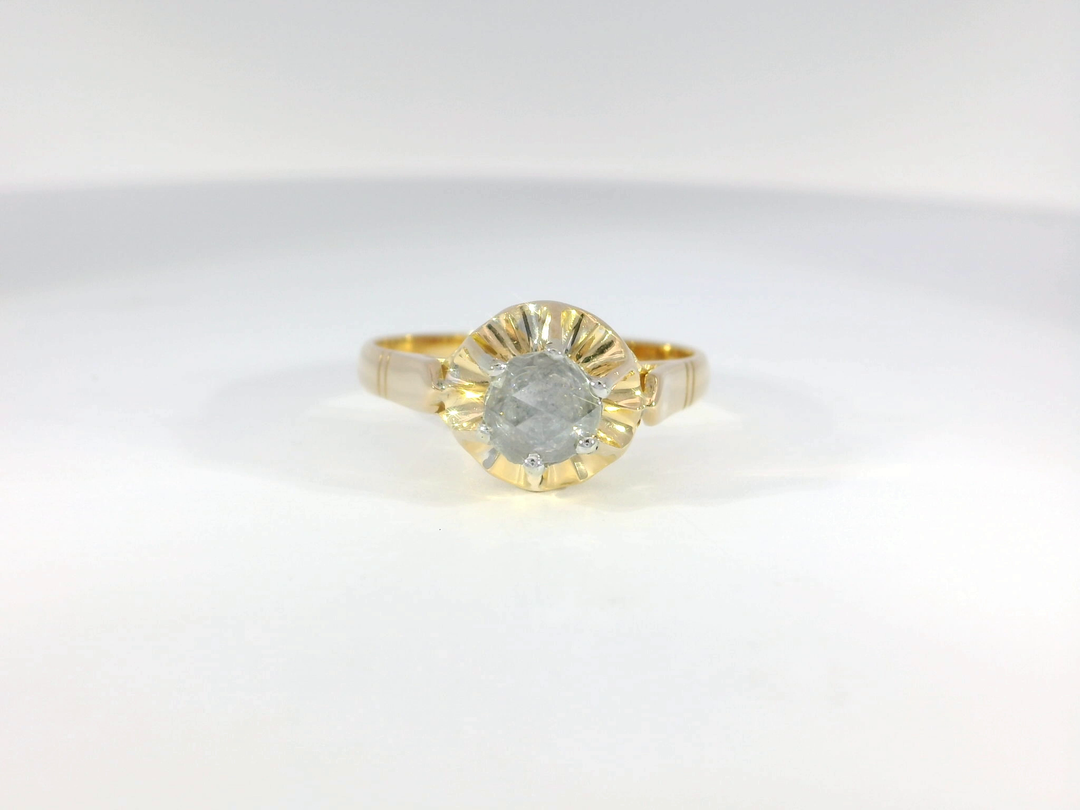 An 18KT yellow gold engagement ring with a rose cut diamond centerpiece.