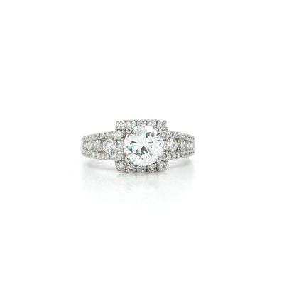 White gold engagement ring with round center diamond and pavé diamond halo setting