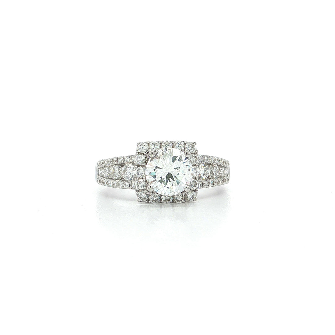 White gold engagement ring with round center diamond and pavé diamond halo setting