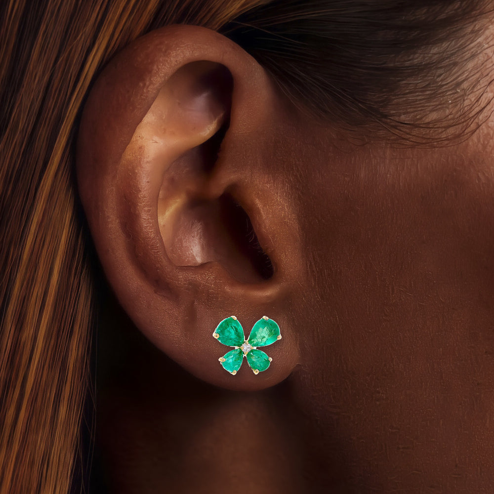 Emerald & Diamond Butterfly Stud Earrings (2 1/10 ct. tw.) in 14k Yellow Gold shown on the ear (deep skin tone)
