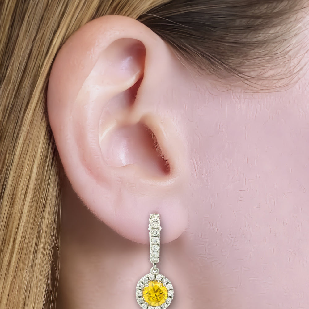 Vivid Yellow Cubic Zirconia Halo Drop Earrings in Sterling Silver shown on the ear (light skin tone)