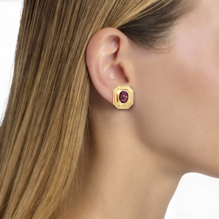 Oval Amethyst Stud Earrings (2 ¾ ct. tw.) in 14k Yellow Gold shown on the ear (light medium skin tone)