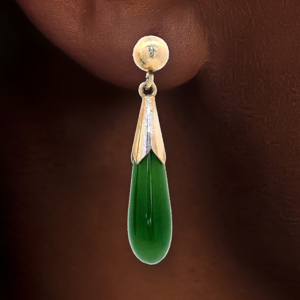 Green Jade Drop Earrings in 14k Yellow Gold shown on the ear (deep skin tone)