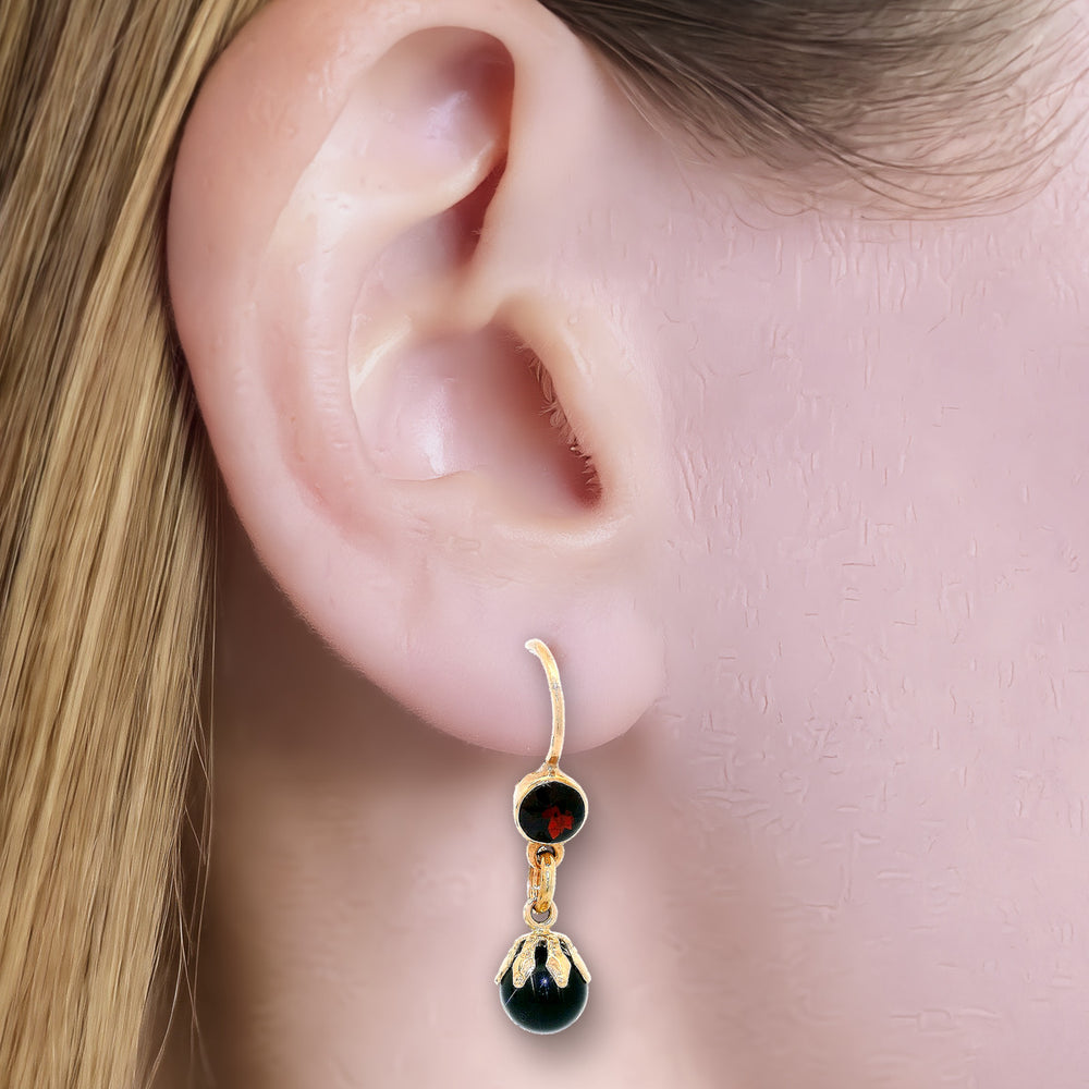 Garnet & Onyx Dangle Earrings (⅘ ct. tw.) in 14k Yellow Gold shown on the ear (light skin tone)