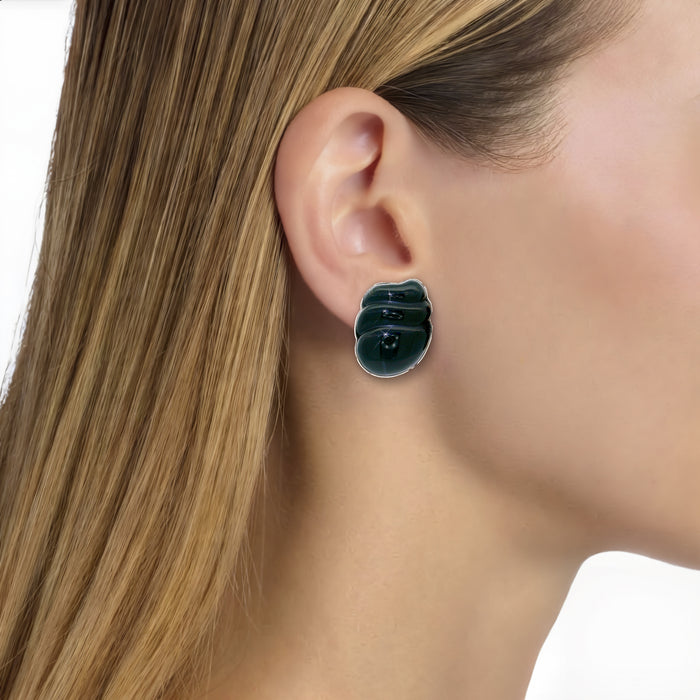 Vintage Onyx Clip-On Earrings in 14k Yellow Gold shown on the ear (light medium skin tone)