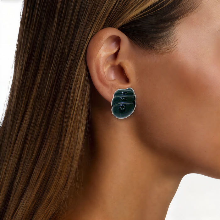 Vintage Onyx Clip-On Earrings in 14k Yellow Gold shown on the ear (medium deep skin tone)