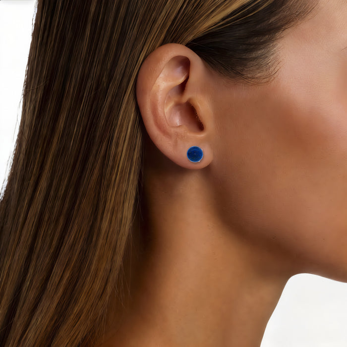 Blue Lapis Lazuli Stud Earrings (8mm) in 18k Yellow Gold shown on the ear (medium deep skin tone)