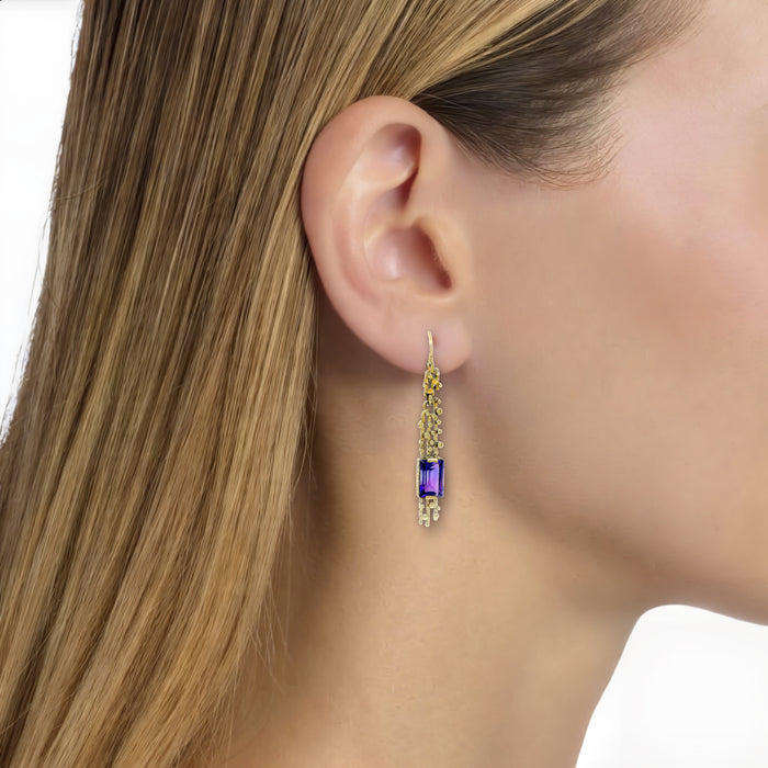 Emerald-Cut Vivid Amethyst Dangle Earrings (1 ct. tw.) in 14k Yellow Gold shown on the ear (light medium skin tone)