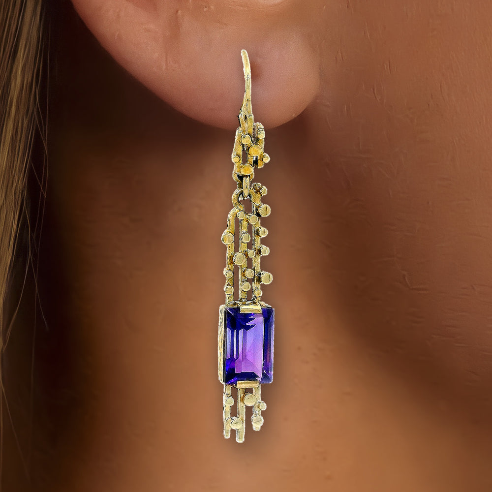 Amethyst Dangle Earrings (1 ct. tw.) in 14k Yellow Gold shown on the ear (medium deep skin tone)