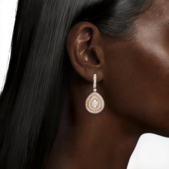 Pear-Shaped Diamond Dangle Earrings (2 ⅘ ct. tw.) in 14k Rose Gold shown on the ear (deepest skin tone)