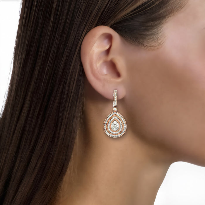 Pear-Shaped Diamond Dangle Earrings (2 ⅘ ct. tw.) in 14k Rose Gold shown on the ear (medium skin tone)
