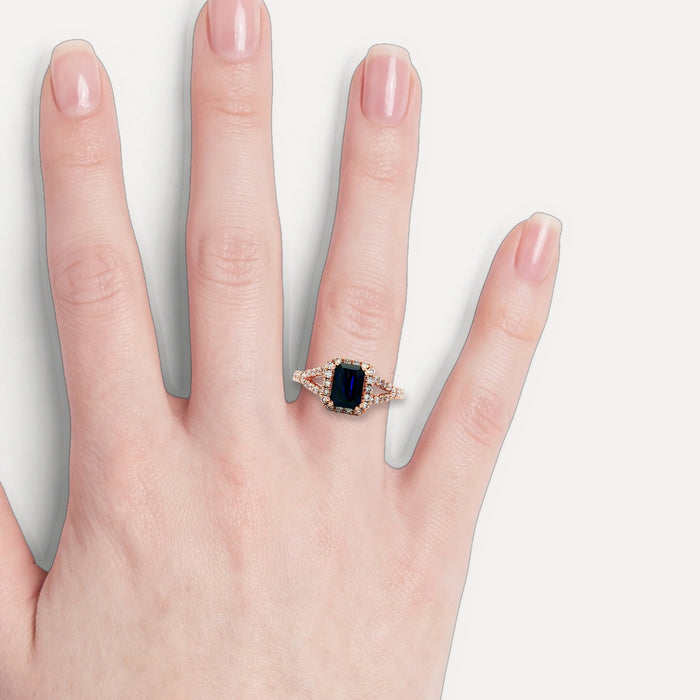 Emerald-Cut Deep Blue Sapphire Diamond Halo Ring (1 ⅚ ct. tw.) in 14k Rose Gold shown on a hand (light skin tone)