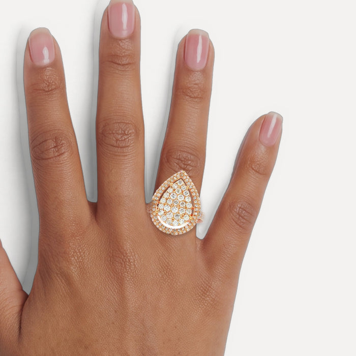 Pear-Shaped Nearly Flawless Colorless Diamond Cluster Ring (1 ¼ ct. tw.) in 18k Rose Gold shown on a hand (medium deep skin tone)