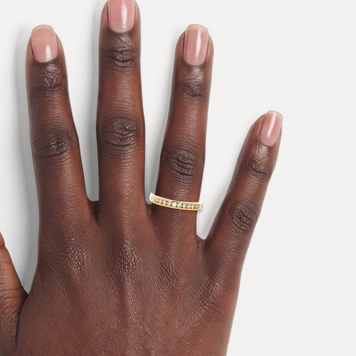Nearly Flawless Colorless Diamond Channel-Set Band (¼ ct. tw.) in 14k Yellow Gold shown on a hand (deep skin tone)