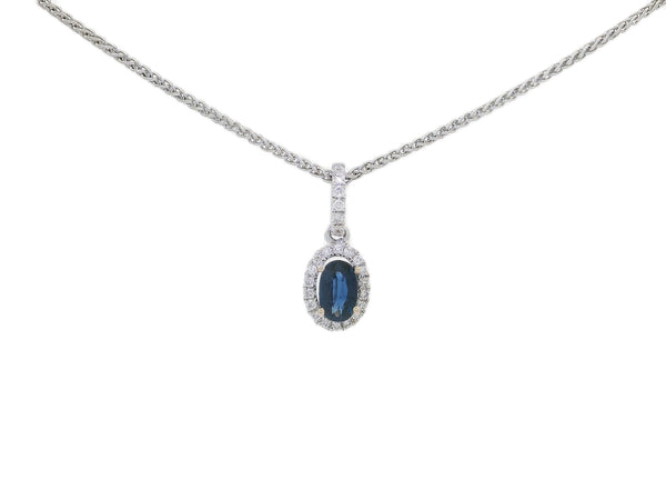 An 18KT white gold pendant necklace with a central oval-shaped sapphire surrounded by a halo of round-cut diamonds.
