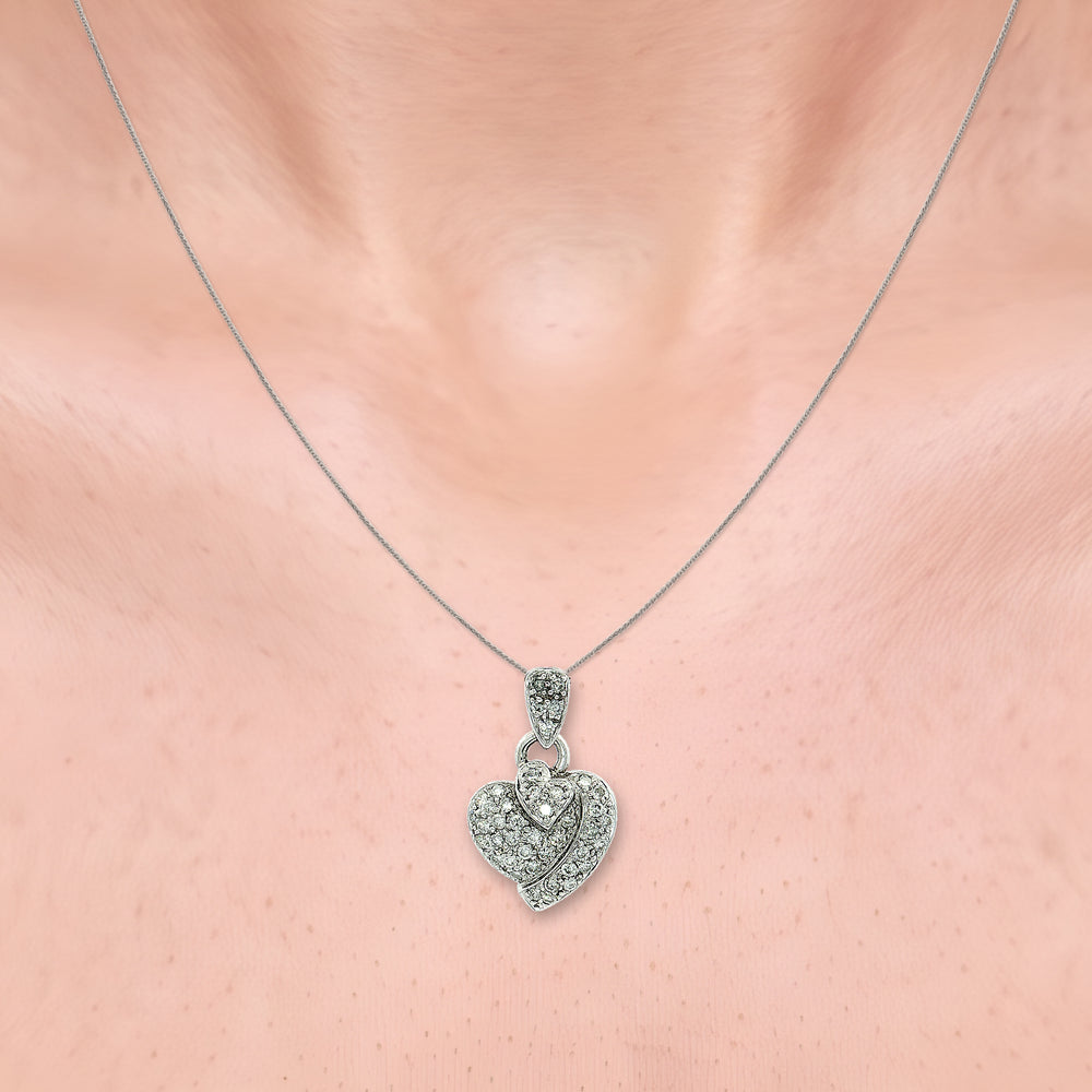 Pavé Colorless Nearly Flawless Diamond Triple Heart Pendant Necklace (½ ct. tw.) in 18k White Gold shown on the neck (light skin tone)