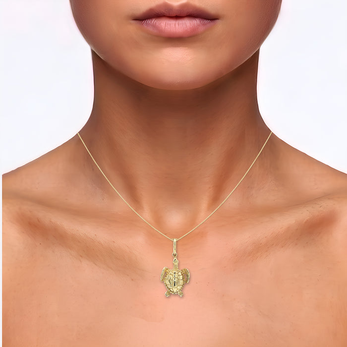 Sea Turtle Pendant Necklace in Solid 14k Yellow Gold shown on the neck (medium skin tone)
