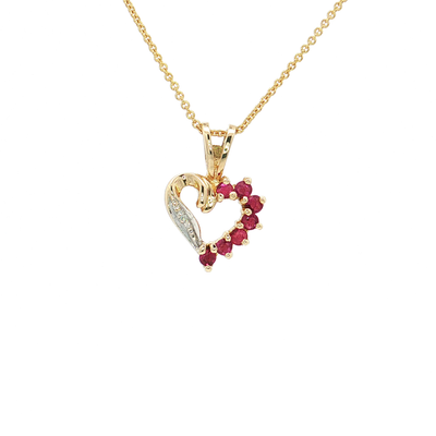 A gold heart-shaped pendant necklace featuring a curved gold swan motif on one side, a row of small clear stones on the other, and a border of red gemstones, shown on a white background.