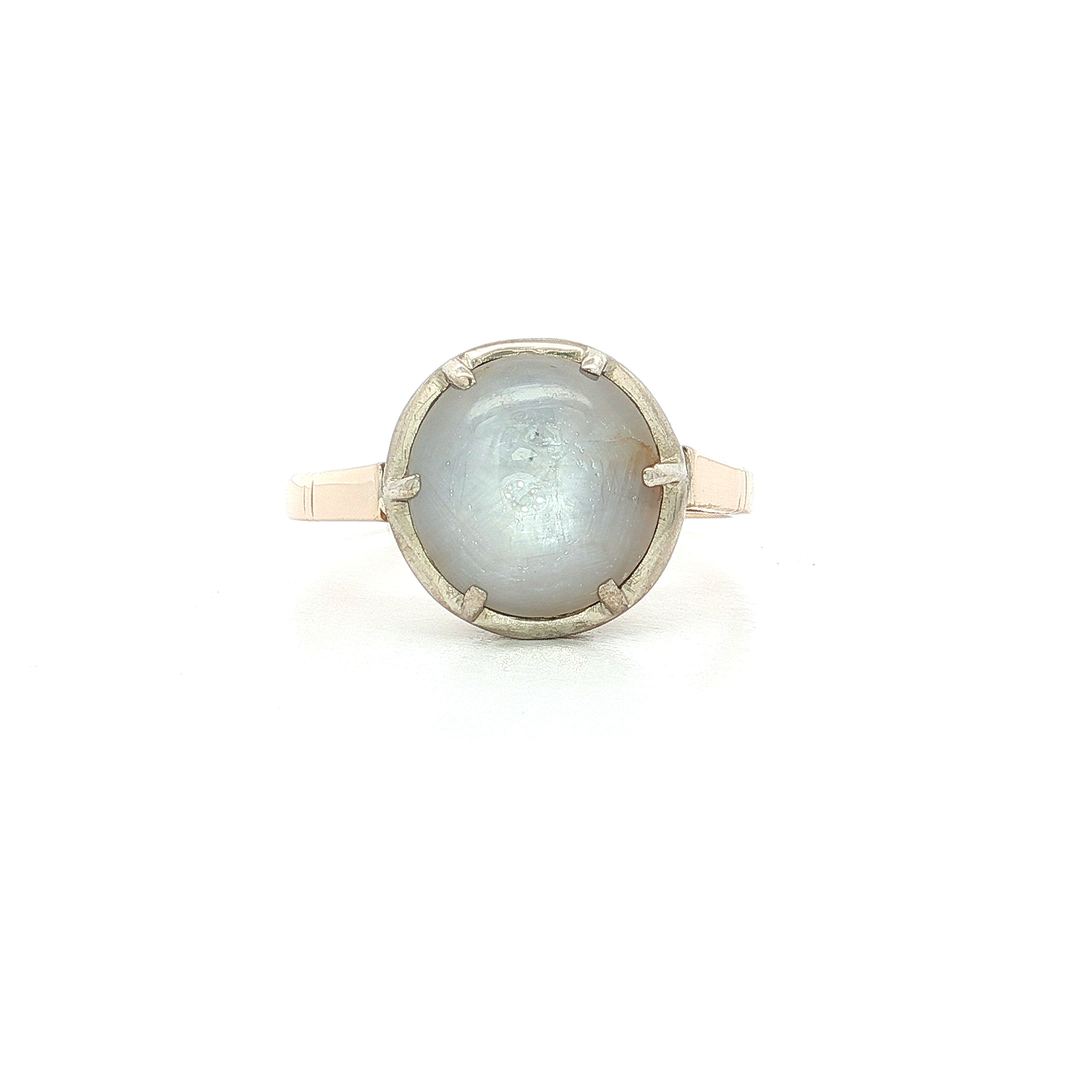 Vintage round moonstone ring with silver prong setting on white background