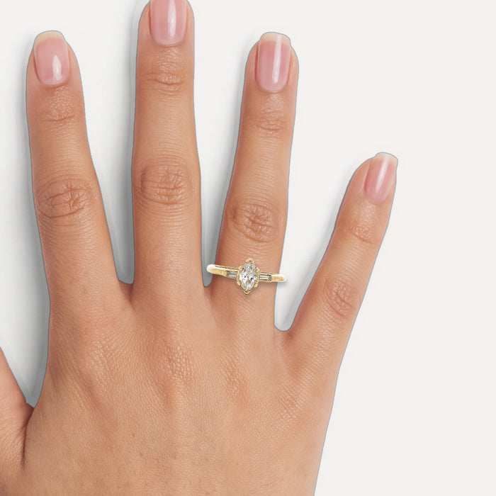 Marquise Baguette Colorless Diamond Engagement Ring (⅗ ct. tw.) in 14k Yellow Gold shown on a hand (medium skin tone)