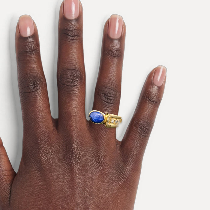 0.15 Carat Lindy Star Sapphire & Diamond Ring in 14k Yellow Gold shown on a hand (deep skin tone)