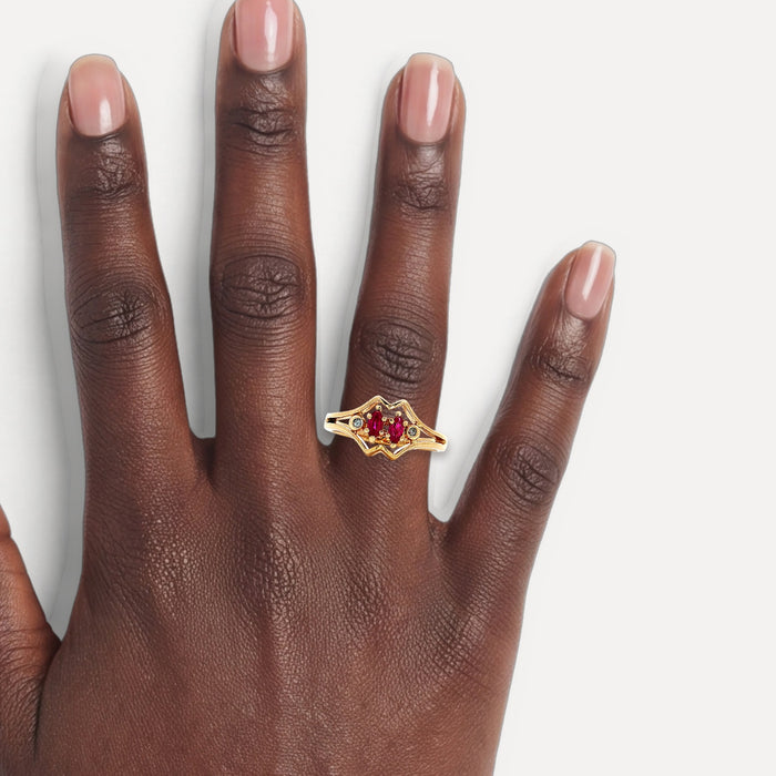Vintage Marquise Brilliant Cut Ruby & Round Brilliant Cut Diamond Bypass Ring in 14k Yellow Gold shown on a hand (deep skin tone)