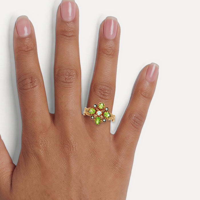Antique Edwardian Oval Vivid Peridot Pearl Flower Cluster Ring (1 ct. tw.) in 9k Yellow Gold shown on a hand (medium deep skin tone)